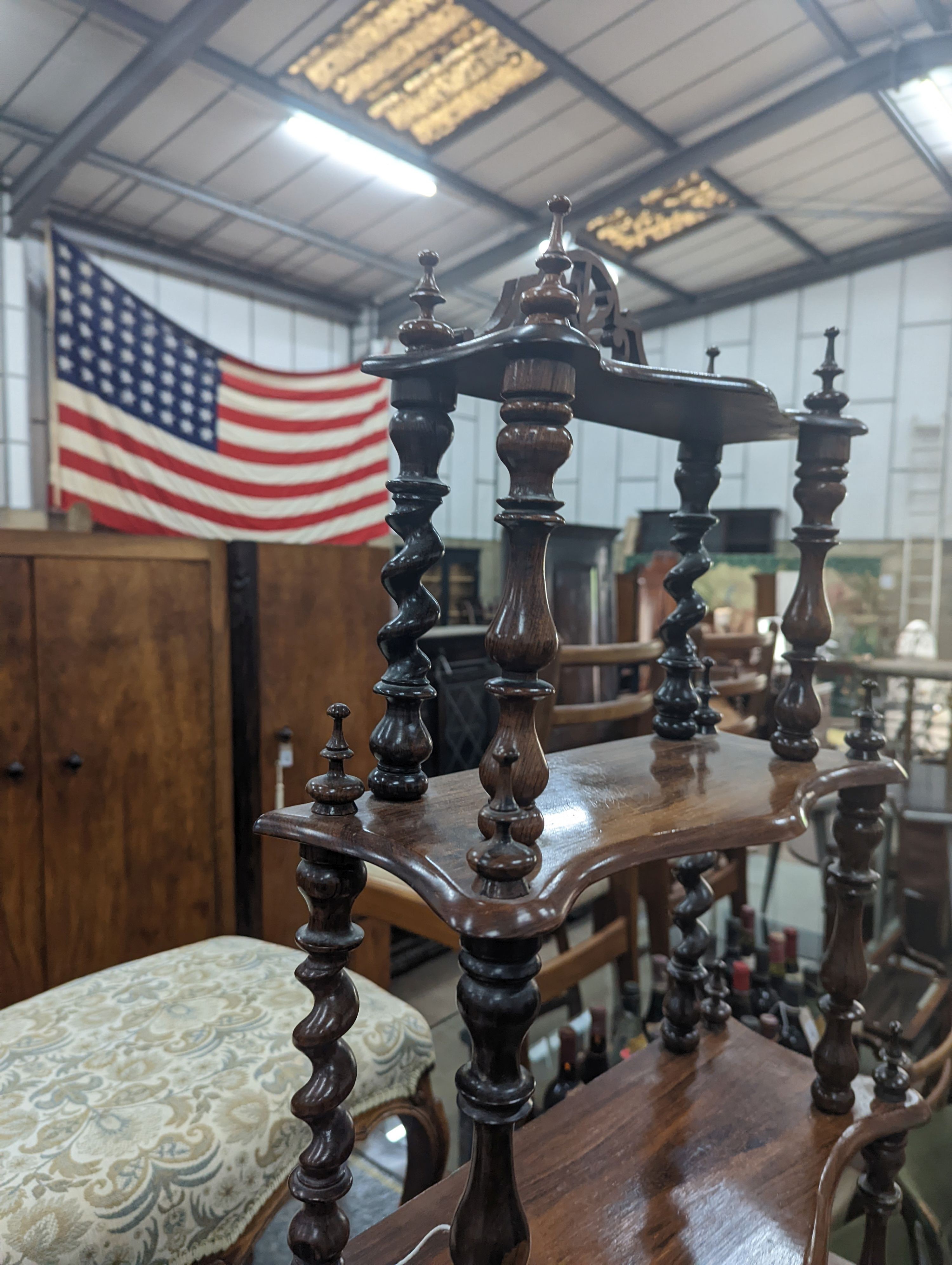 A small Victorian rosewood serpentine fronted four tier whatnot, width 61cm, depth 21cm, height 94cm